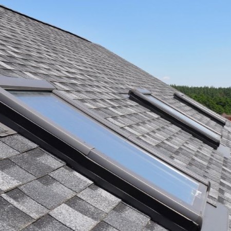 Angled view of skyulights in a row on a residential rooftop